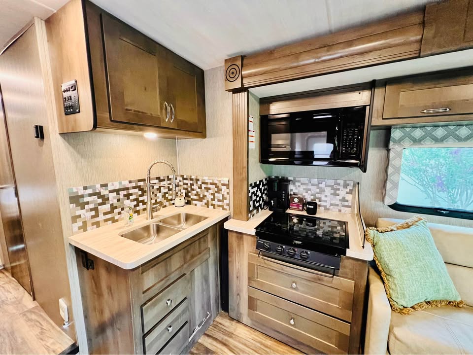 Kitchen with sink, stove, and microwave